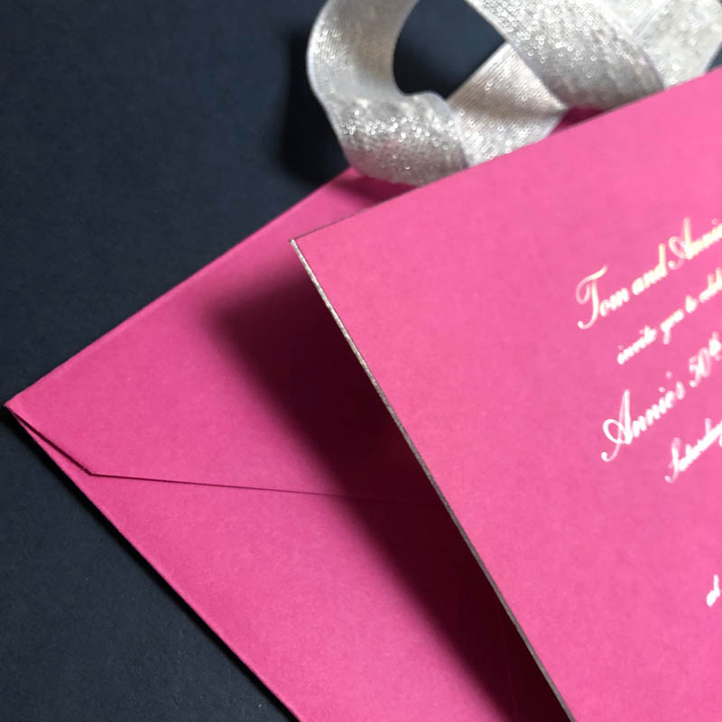 Pink wedding invitation with matching envelopes